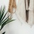 towels hanging on a wall near a plant