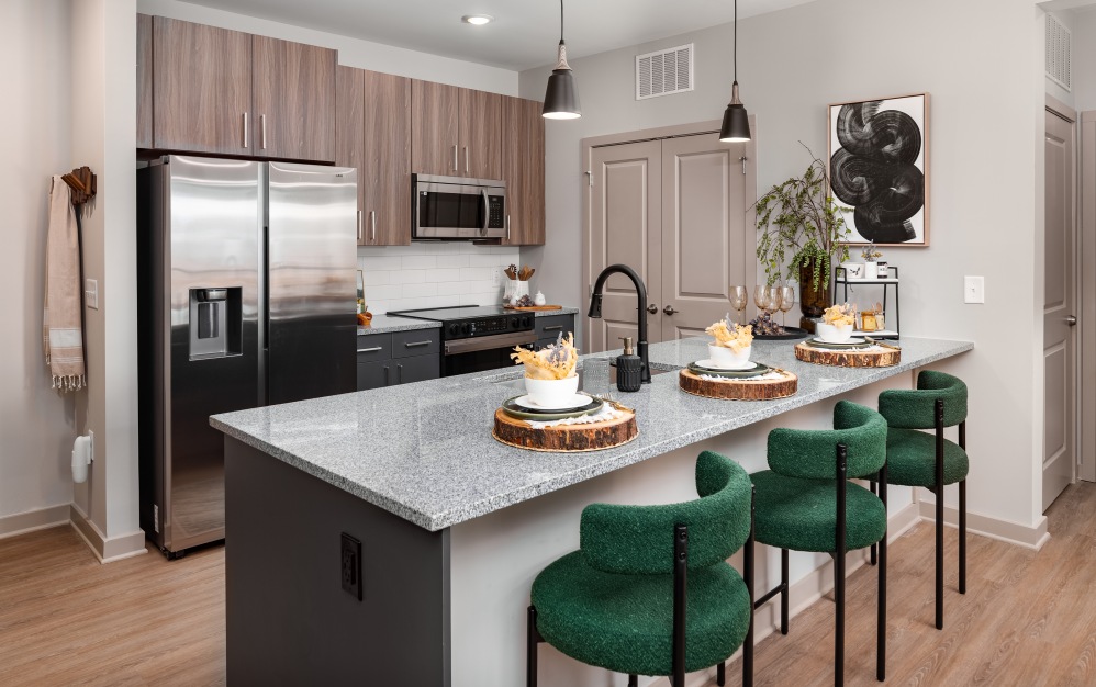 Luxury kitchen with breakfast bar at Ava Oakwood apartment complex in Gainesville	